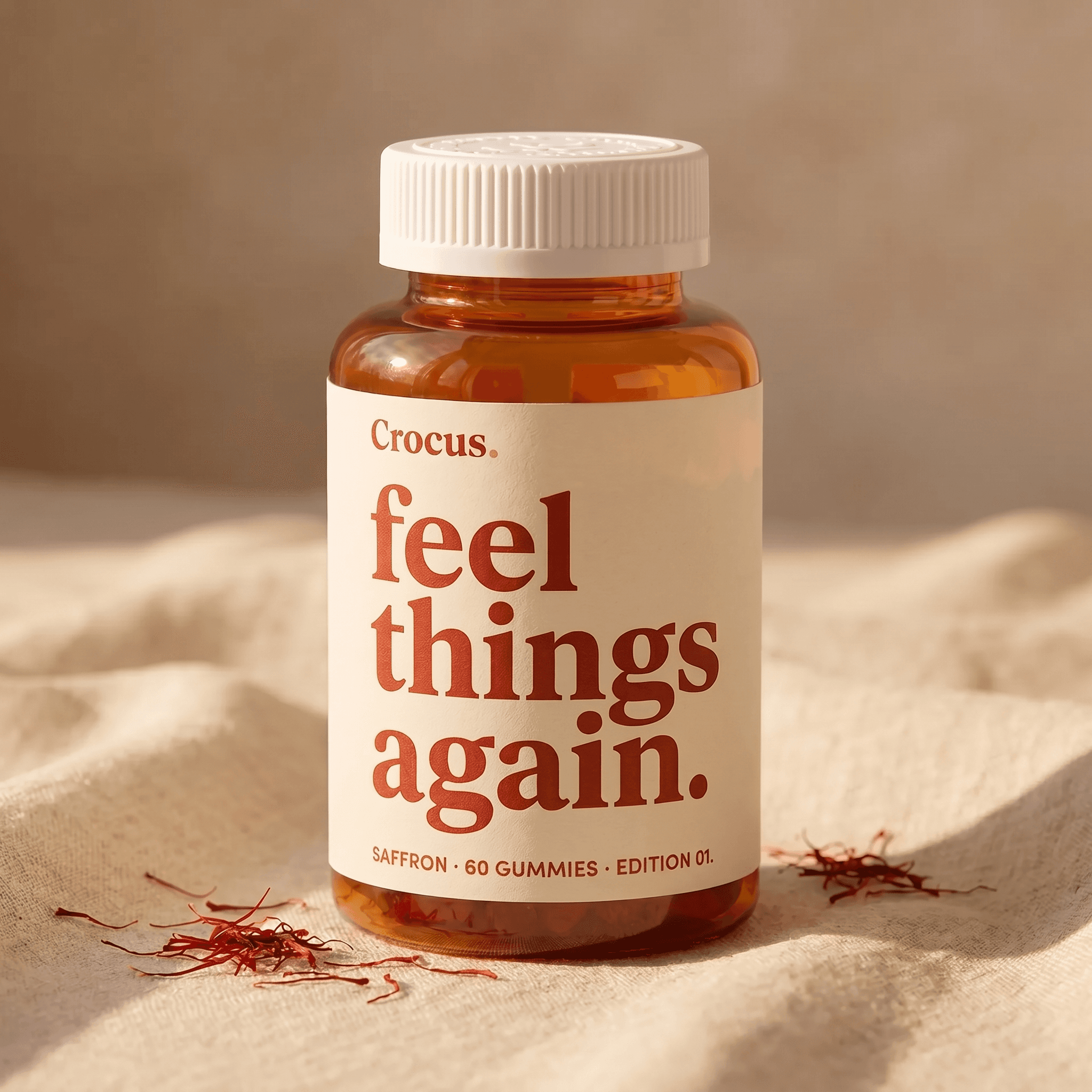 Crocus Spark amber jar on warm linen with saffron threads