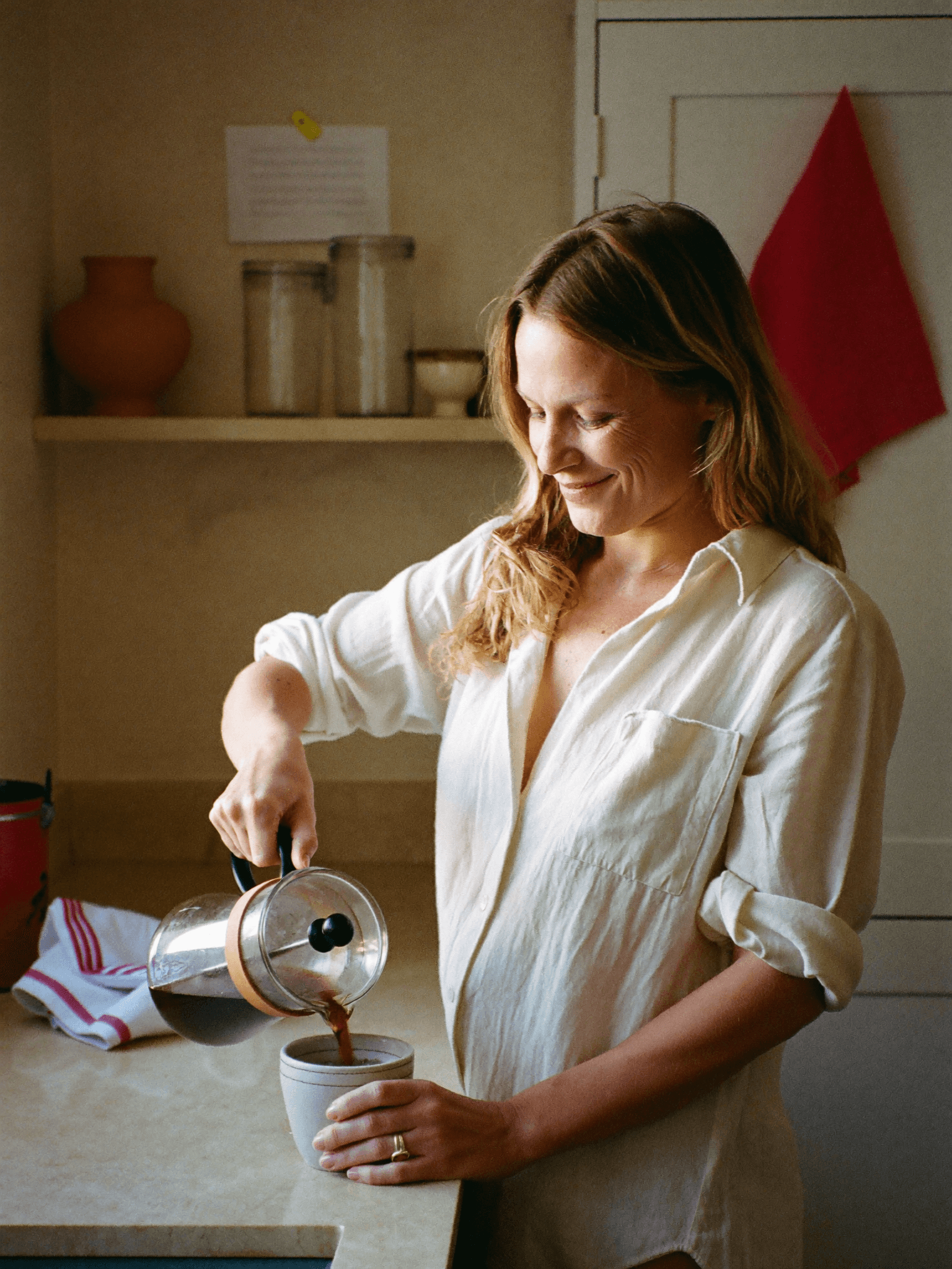 Maren K., founder of Crocus, pouring coffee in her sun-filled kitchen